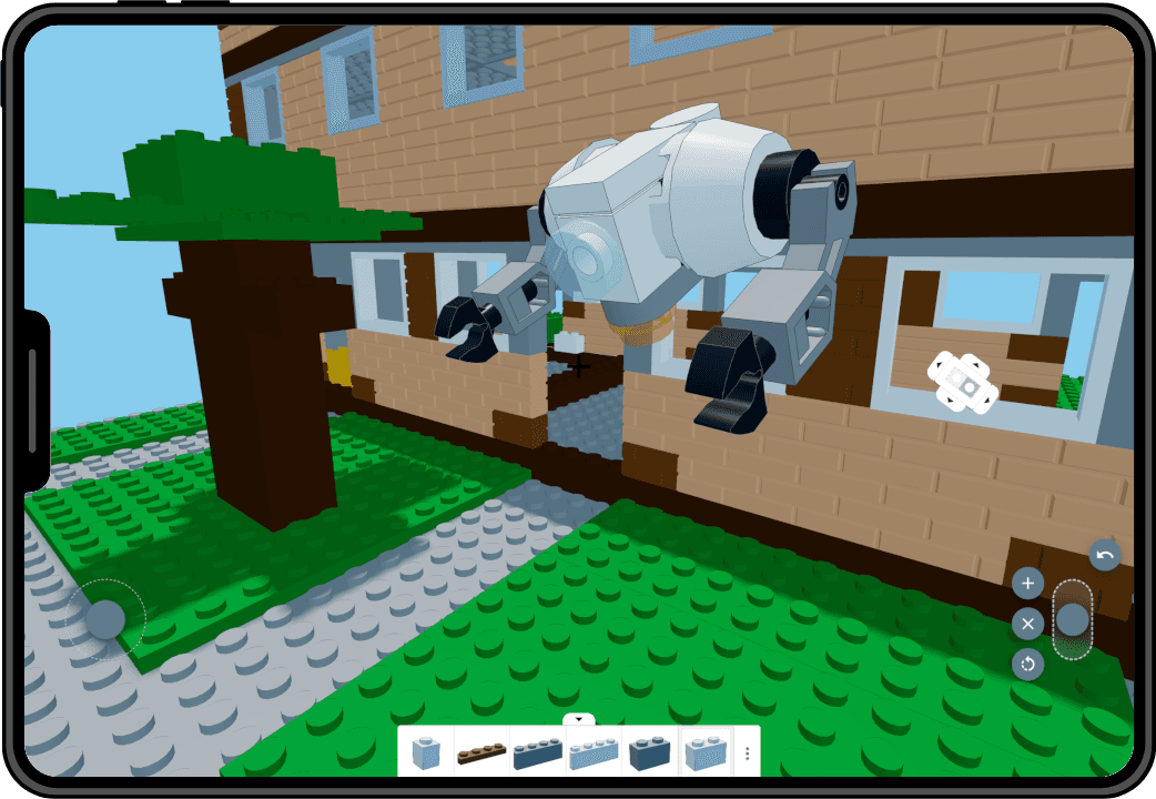 BlocksFusion editor on a tablet displaying a brick-built scene with a camera model in the foreground